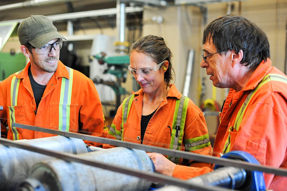 Students and instructor working with machinery