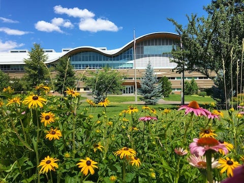 flowers in front of Old Main Building at Kamloops campus